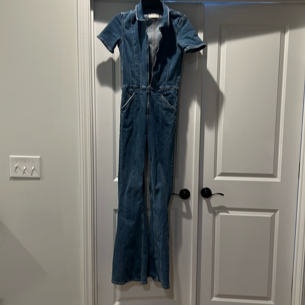 Jean jump suit . Zipper front closure. Short sleeves with front pockets.